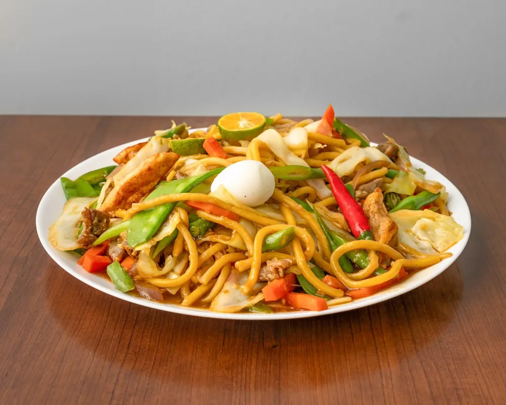 Pancit Guisado, Filipino stir-fried egg noodles with pork, vegetables and calamansi at Sagana Foods, Filipino restaurant in Calgary, AB